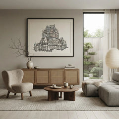 A large framed black and white architectural art print of a castle, displayed on a neutral gray wall in a modern, minimalist living room with a wooden credenza, textured armchair, and coffee table.